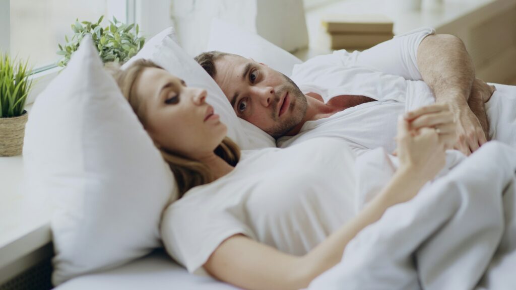 couple-allonge-dans-le-lit-ensemble